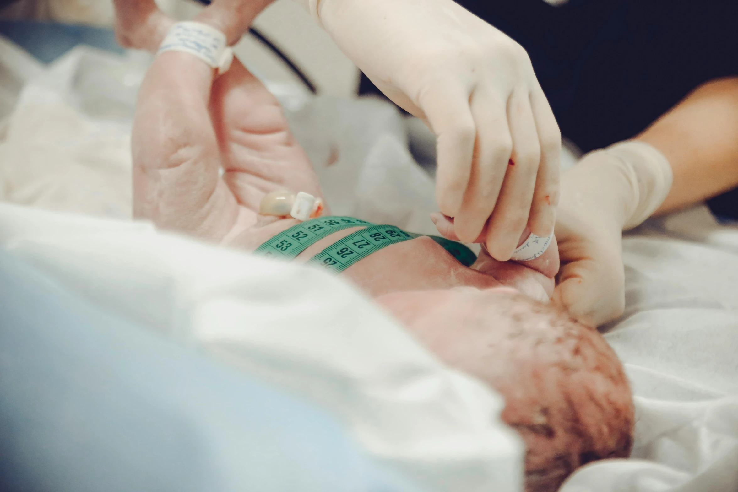 a close up of a person in a hospital bed, the birth, colour corrected, touching, cast