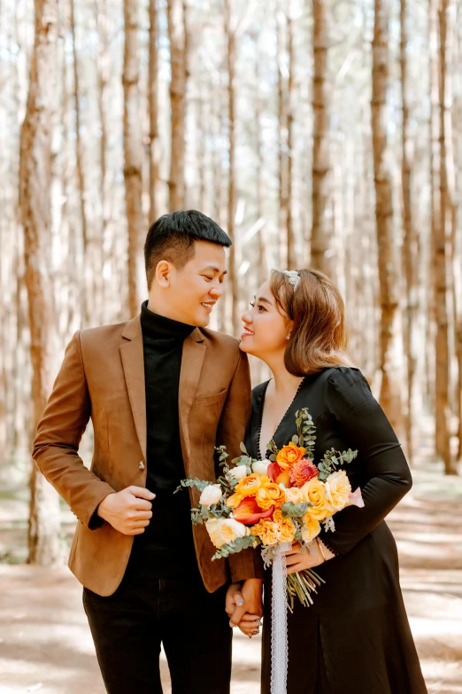 a man and woman standing next to each other in a forest, a picture, inspired by Ruth Jên, unsplash, bouquets, in style of lam manh, smiling at each other, a wooden