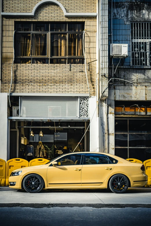 a yellow car parked in front of a building, a picture, pexels contest winner, touareg, ✨🕌🌙, sitting down, north melbourne street