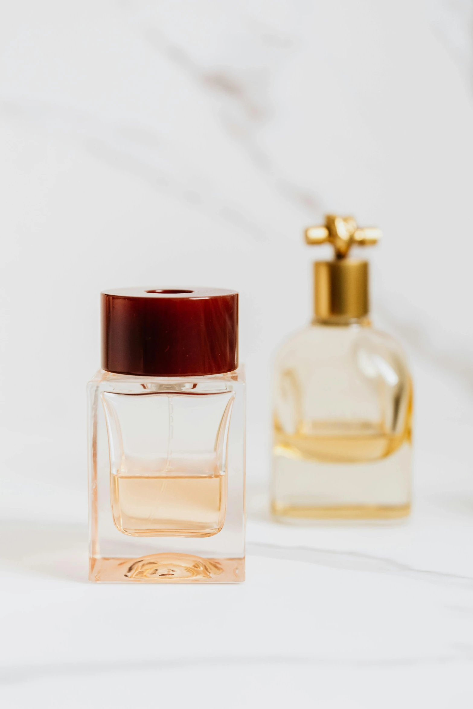 two bottles of perfume sitting next to each other, detailed product image, zoomed in shots, portrait shot, small in size