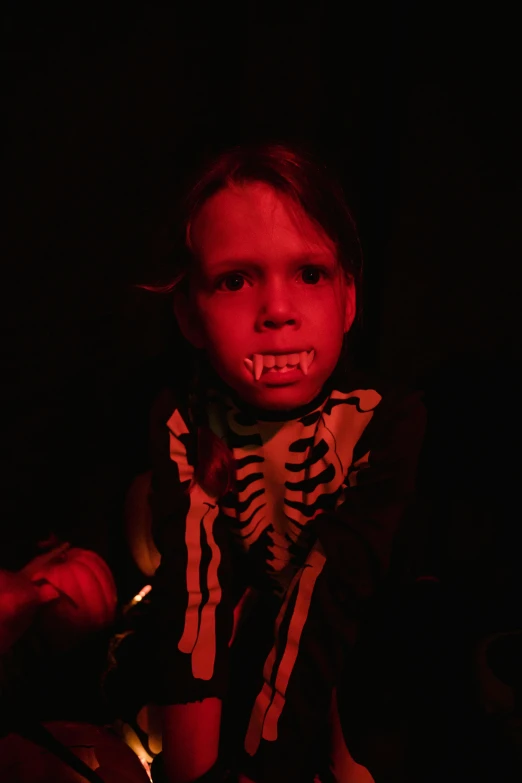 a little girl that is sitting in the dark, reddit, vanitas, dracula fangs! haunted house, young boy, greta thunberg, monster teeth covered in red