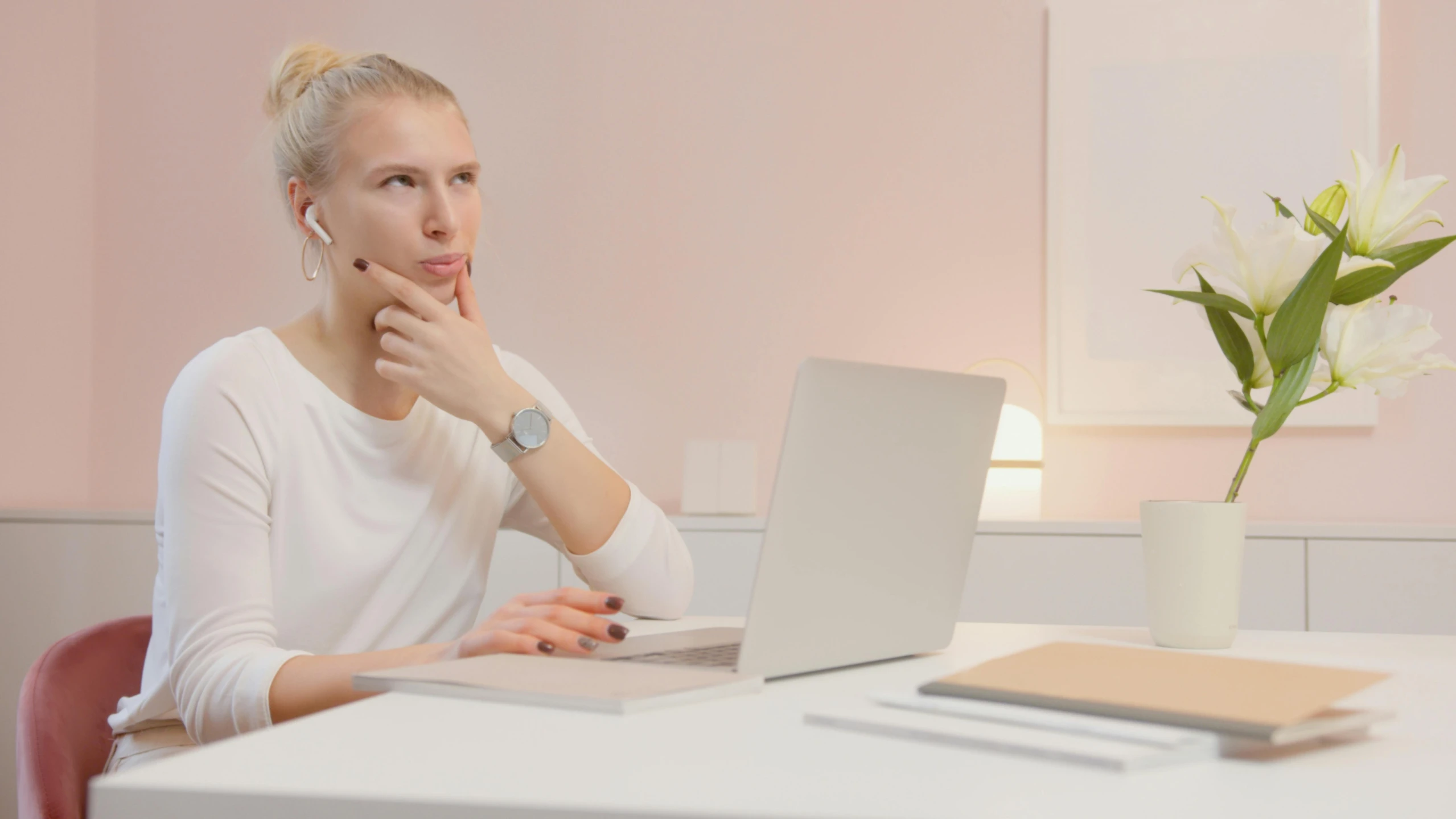 a woman sitting at a table using a laptop computer, a computer rendering, trending on pexels, distant thoughtful look, in white room, glowing aesthetic, looking content