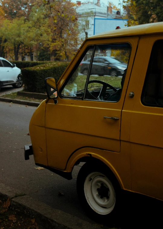 a yellow van parked on the side of the road, unsplash, hyperrealism, 1 9 7 0 s analog video, 🍂 cute, kama russian electrocar, italian