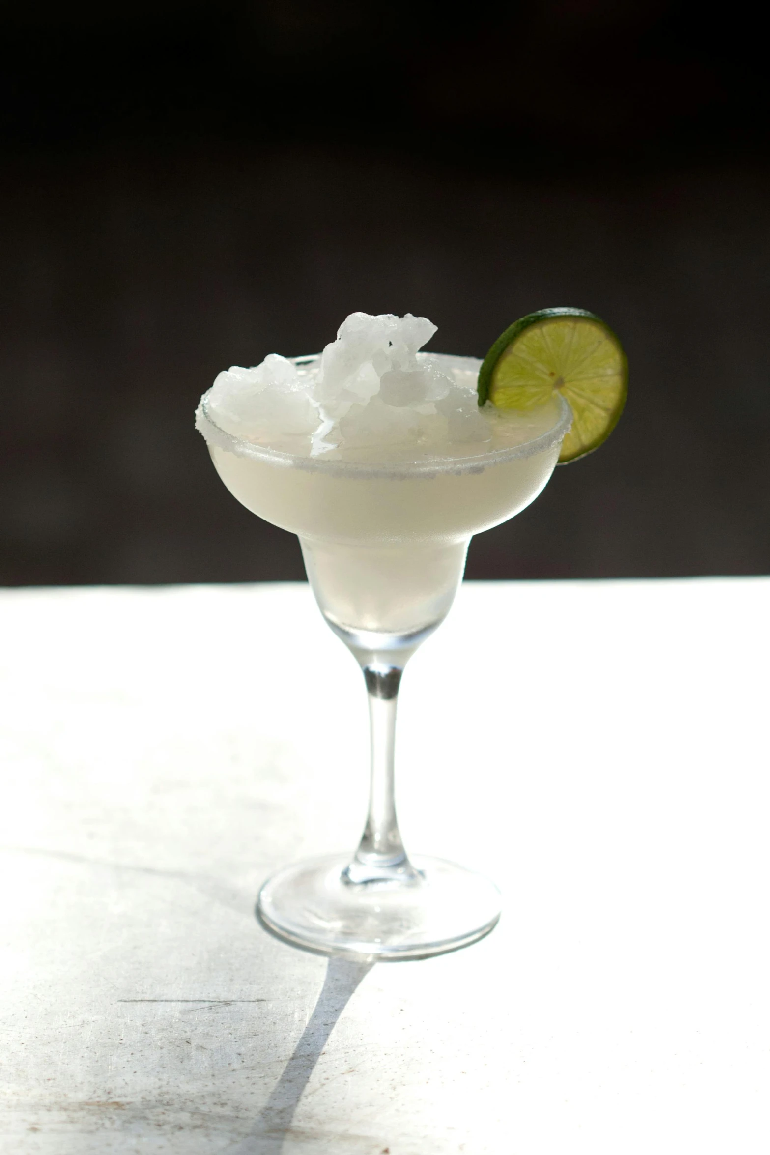 a margarita sitting on top of a white table, foam, rice, limestone, iceberg