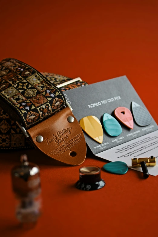 a guitar pick case sitting on top of a table, a picture, middle eastern details, material pack, various items, thumbnail