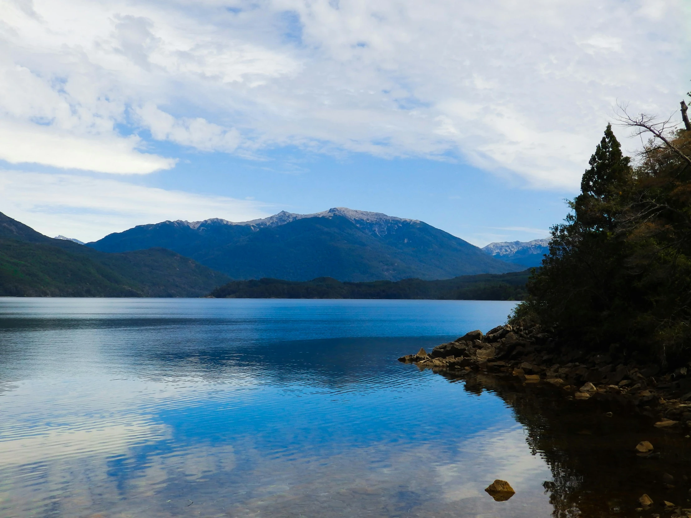 a body of water with mountains in the background, a picture, inspired by Juan O'Gorman, unsplash, hurufiyya, chilean, avatar image, whistler