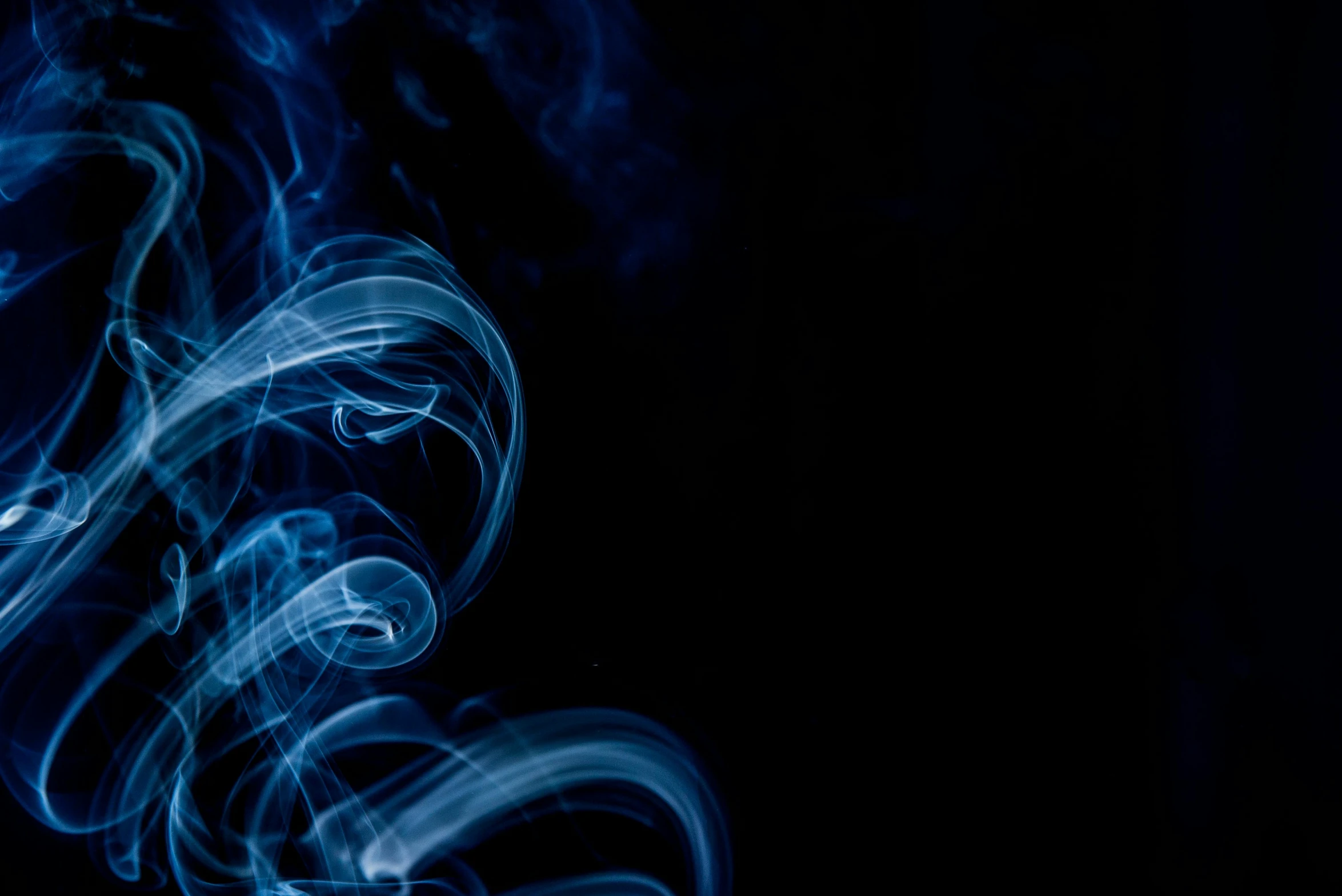 a close up of smoke on a black background, an album cover, pexels contest winner, glowing tiny blue lines, desaturated blue, background ( dark _ smokiness ), chewing tobacco