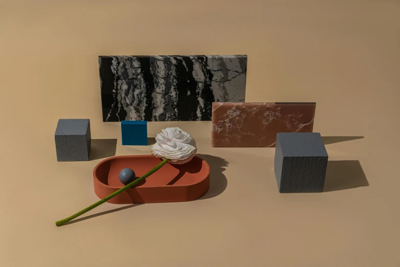 a white rose sitting on top of a red bowl, a still life, inspired by Bauhaus, trending on polycount, bauhaus, black marble, blocks, low - relief stone sculpture, gray and orange colours