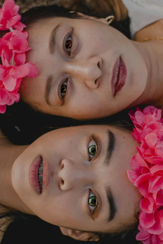 two women laying next to each other with flowers in their hair, inspired by Ren Hang, unsplash, photoshoot for skincare brand, south east asian with round face, high angle closeup portrait, video