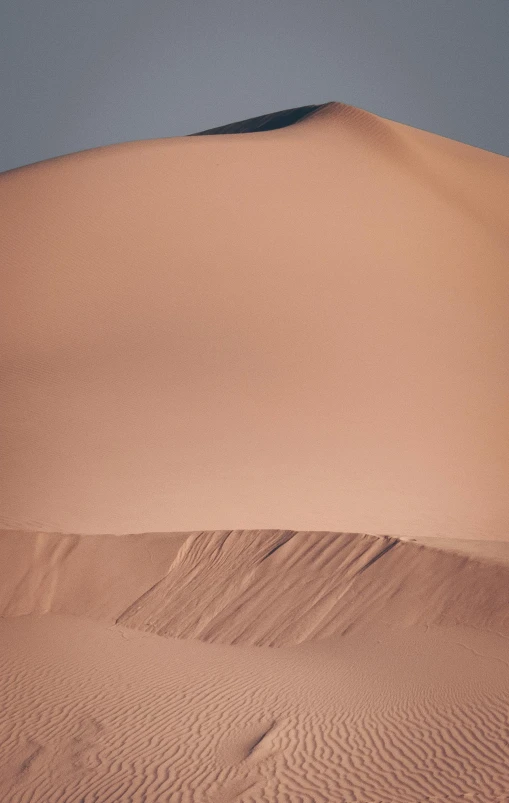 a large sand dune in the middle of a desert, trending on unsplash, in shades of peach, high detail photograph, background image, stacked image