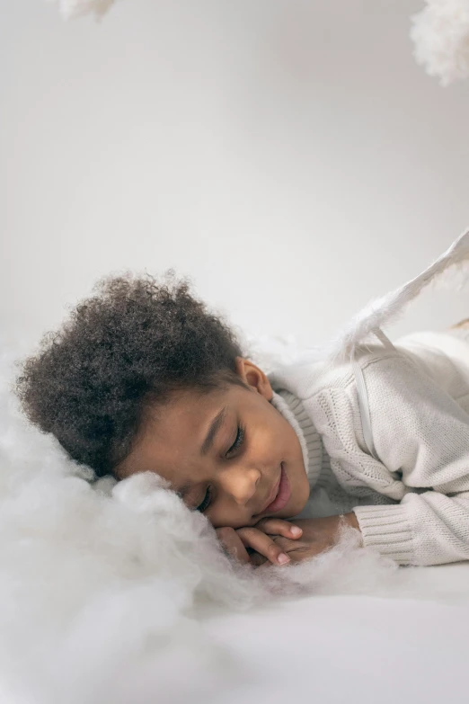 a little girl laying on top of a cloud, inspired by Sophie Anderson, pexels contest winner, portrait willow smith, winged boy, white hue, cozy studio photography