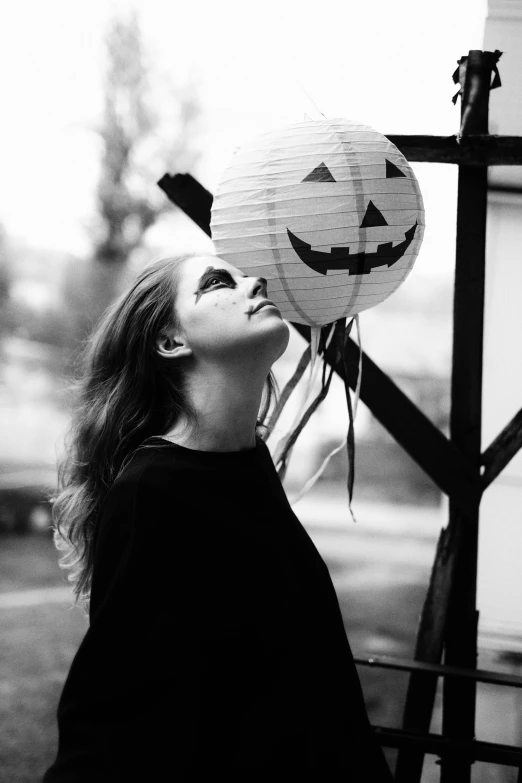 a black and white photo of a woman holding a paper lantern, inspired by Taro Yamamoto, tumblr, pumpkin head, profile picture, 🍂 cute, anna nikonova aka newmilky