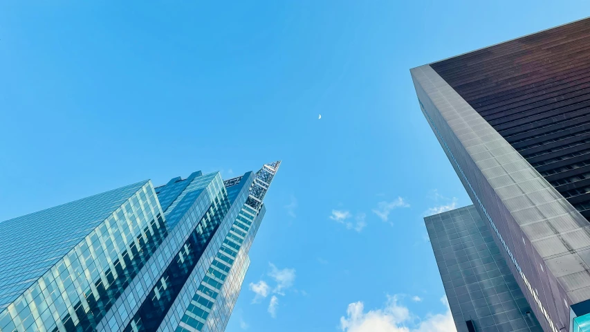 a couple of tall buildings sitting next to each other, by Sebastian Vrancx, pexels contest winner, clear blue skies, moma museum, jets, new york city in the year 2100