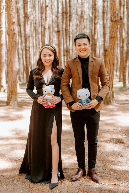 a man and woman standing next to each other in a forest, a cartoon, pexels contest winner, m & m plush, in style of lam manh, studio photo, holding a teddy bear