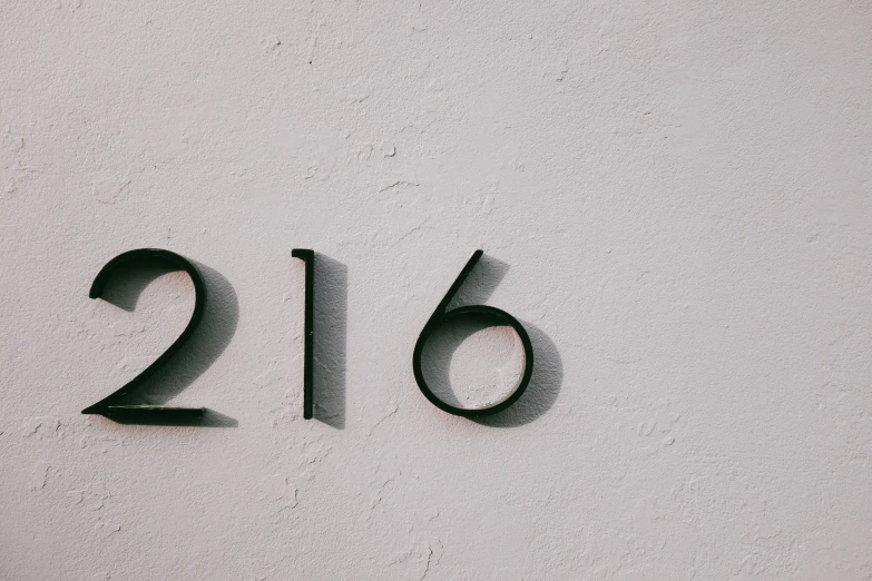 a close up of a number on a wall, trending on unsplash, minimalism, 1820, 12 figures, 2 5 6 x 2 5 6, in front of the house