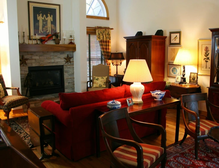 a living room filled with furniture and a fire place, inspired by William Home Lizars, pexels contest winner, couch desk, crimson accents, taken in the late 2010s, a quaint