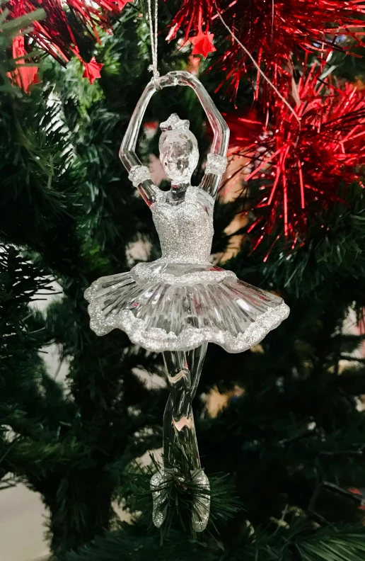 a glass ballerina ornament hanging from a christmas tree, arabesque, with high detail, 🦑 design, posed