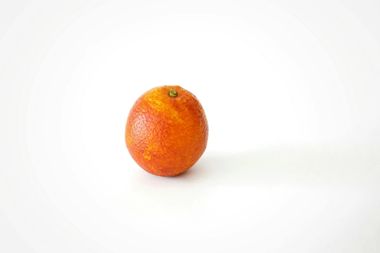 an orange sitting on top of a white surface, by Niels Lergaard, unsplash, photorealism, high quality product photo, red giant, myrtle, wide long view