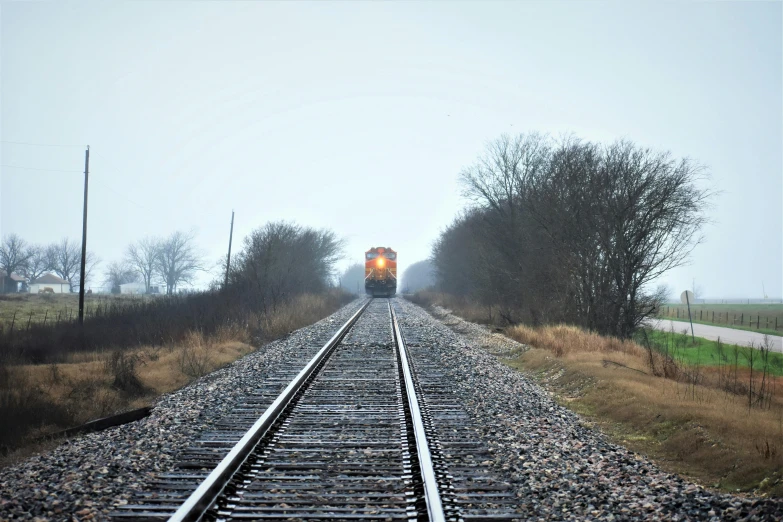 a train traveling down train tracks on a foggy day, unsplash, photorealism, maintenance photo, 2000s photo, outdoor photo, ilustration