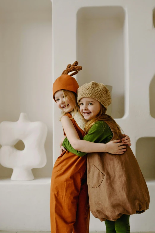 a couple of kids standing next to each other, inspired by Elsa Beskow, unsplash, conceptual art, deerstalker, softplay, brown, press shot