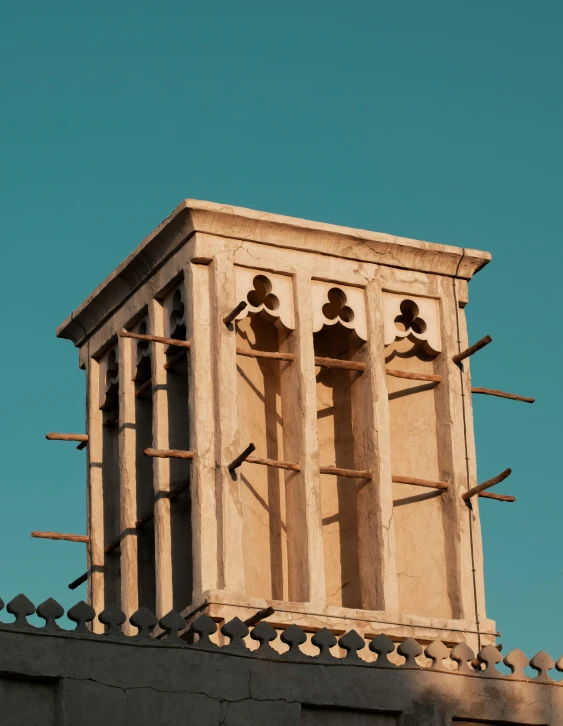 a tall clock tower sitting on top of a building, an album cover, by Riad Beyrouti, trending on pexels, renaissance, ventilation shafts, telephoto, middle eastern skin, odd pipes