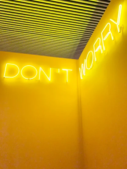 a neon sign that says don't worry on a yellow wall, by Carey Morris, pexels, thin glowing wires, instagram story, museum photo, dasha taran