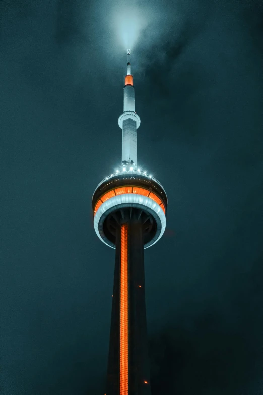the top of a tall tower lit up at night, an album cover, by Adam Marczyński, pexels contest winner, toronto city, orange halo, grayish, neons