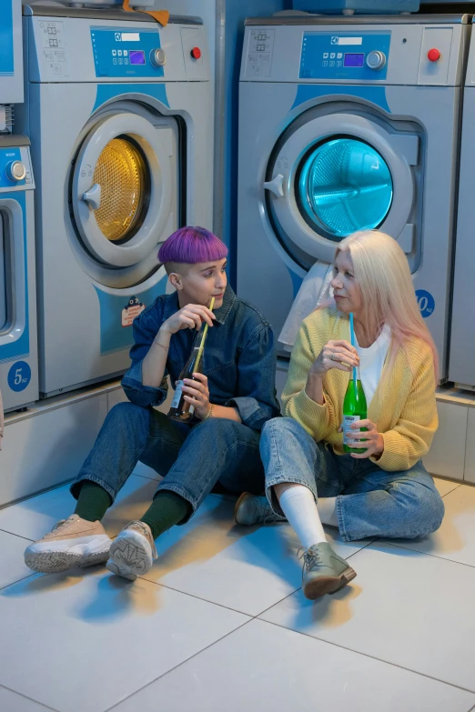 two people sitting on the floor in front of washing machines, inspired by David LaChapelle, renaissance, ava max, drinks, capsule hotel, profile image