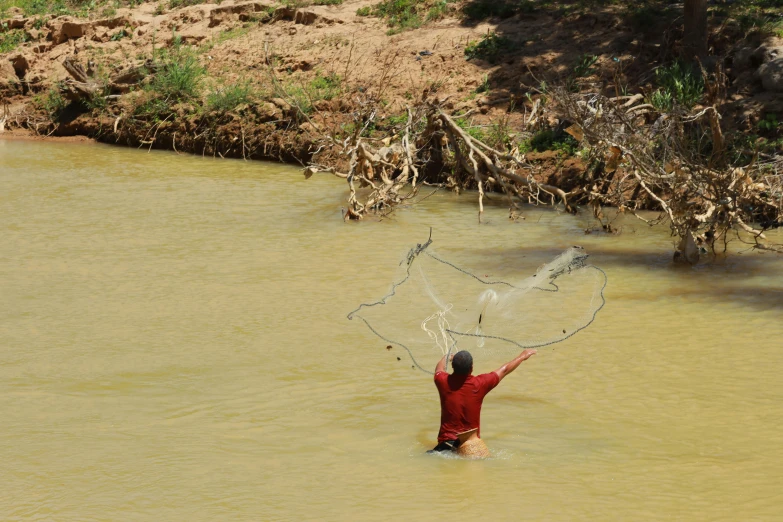 a man that is standing in the water with a net, samburu, two hands reaching for a fish, profile pic, shipibo