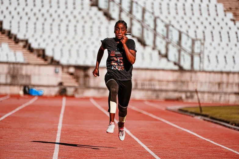 a man running on a track in a stadium, by Daniel Lieske, pexels contest winner, photo of a black woman, 15081959 21121991 01012000 4k, working out in the field, promo image