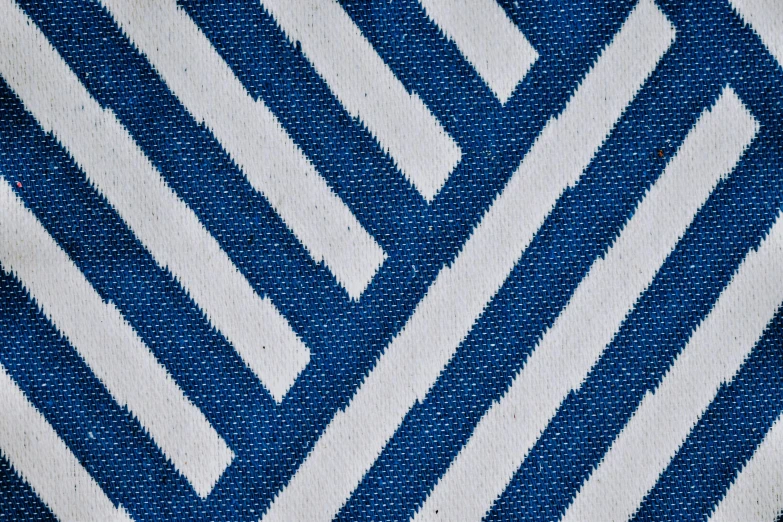 a close up of a blue and white rug, inspired by Fernando Gerassi, diagonal lines, medium blue, cotton fabric, maze