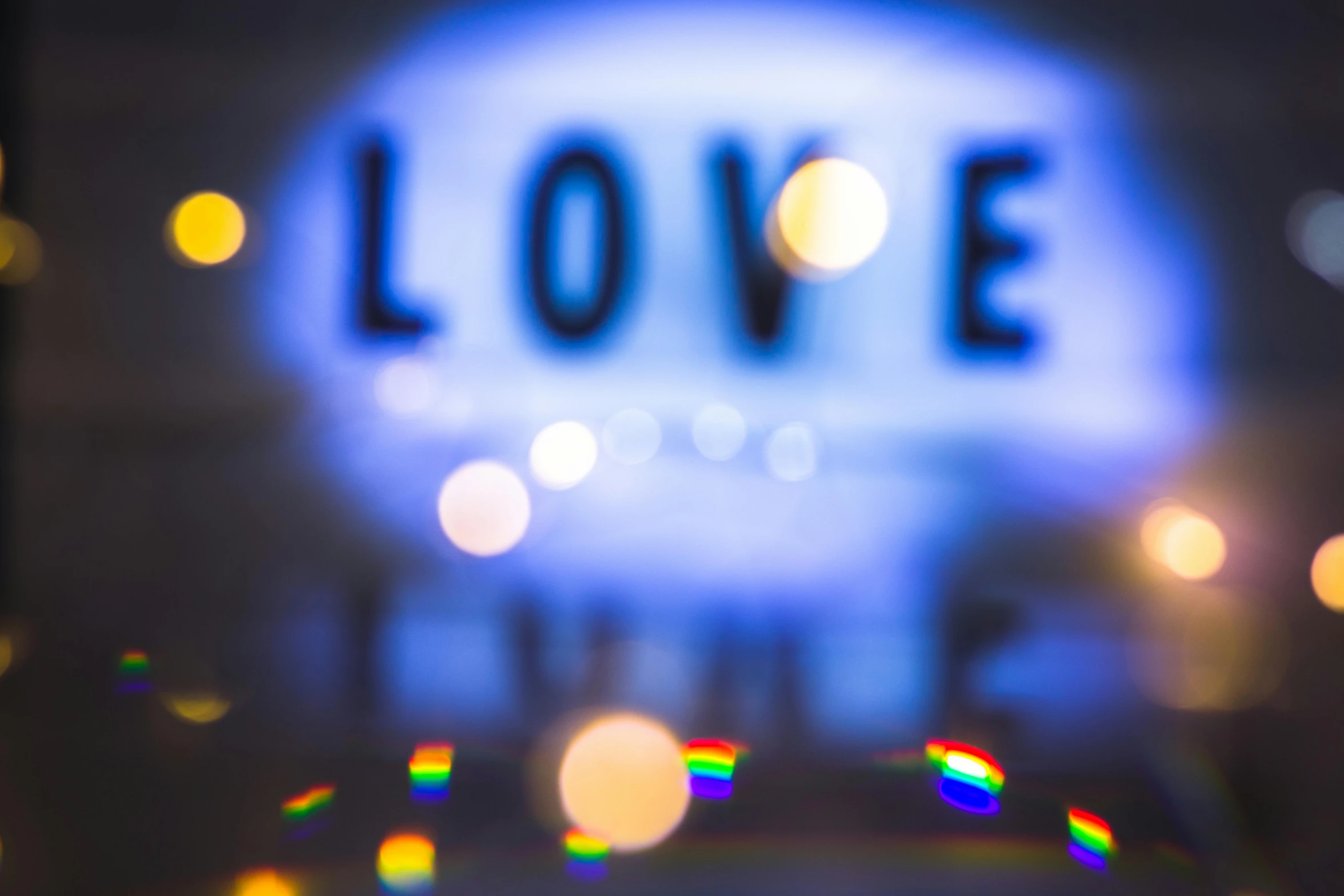 a glass of wine sitting on top of a table, a picture, by Joe Bowler, unsplash, light and space, double exposure of love, colorful signs, bokeh. i, love hate love