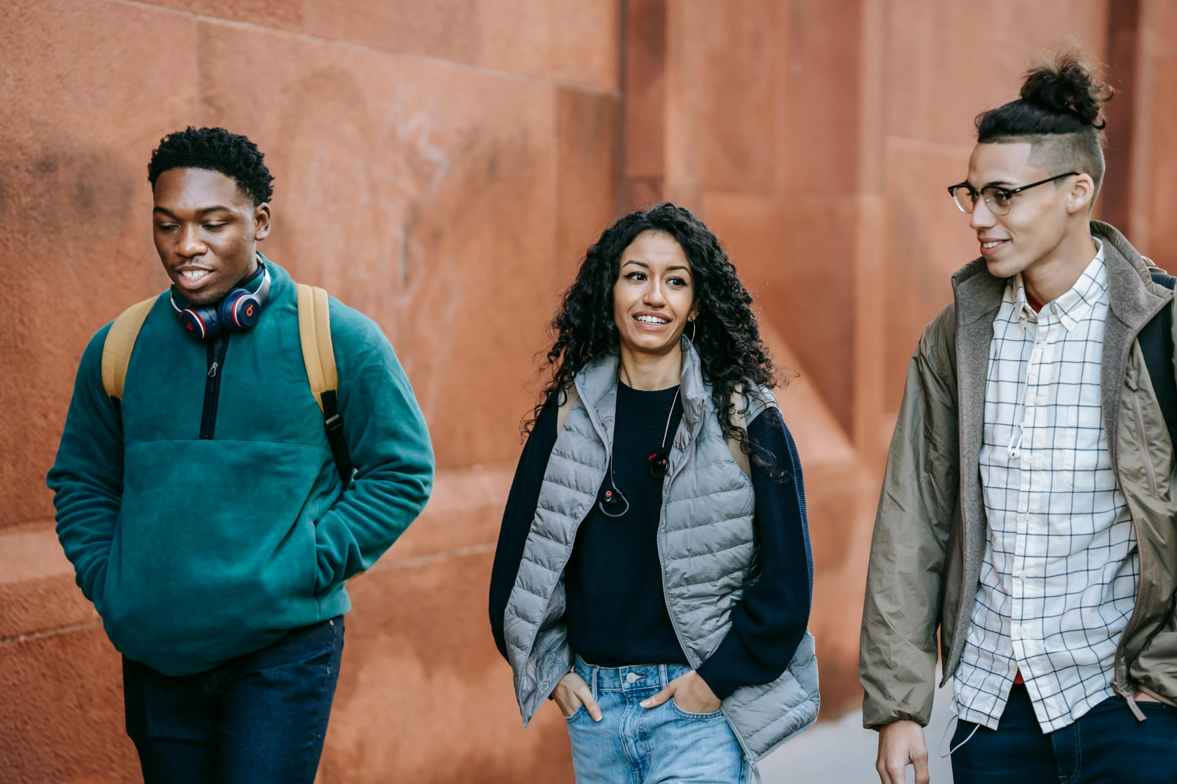 a group of young people walking down a sidewalk, trending on pexels, renaissance, three heads, brown skinned, student, contemplating