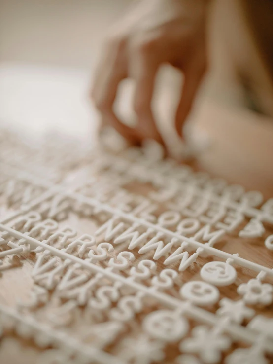 a close up of a person cutting a cake, glyphs, detailed product image, typographical experiments, clay model