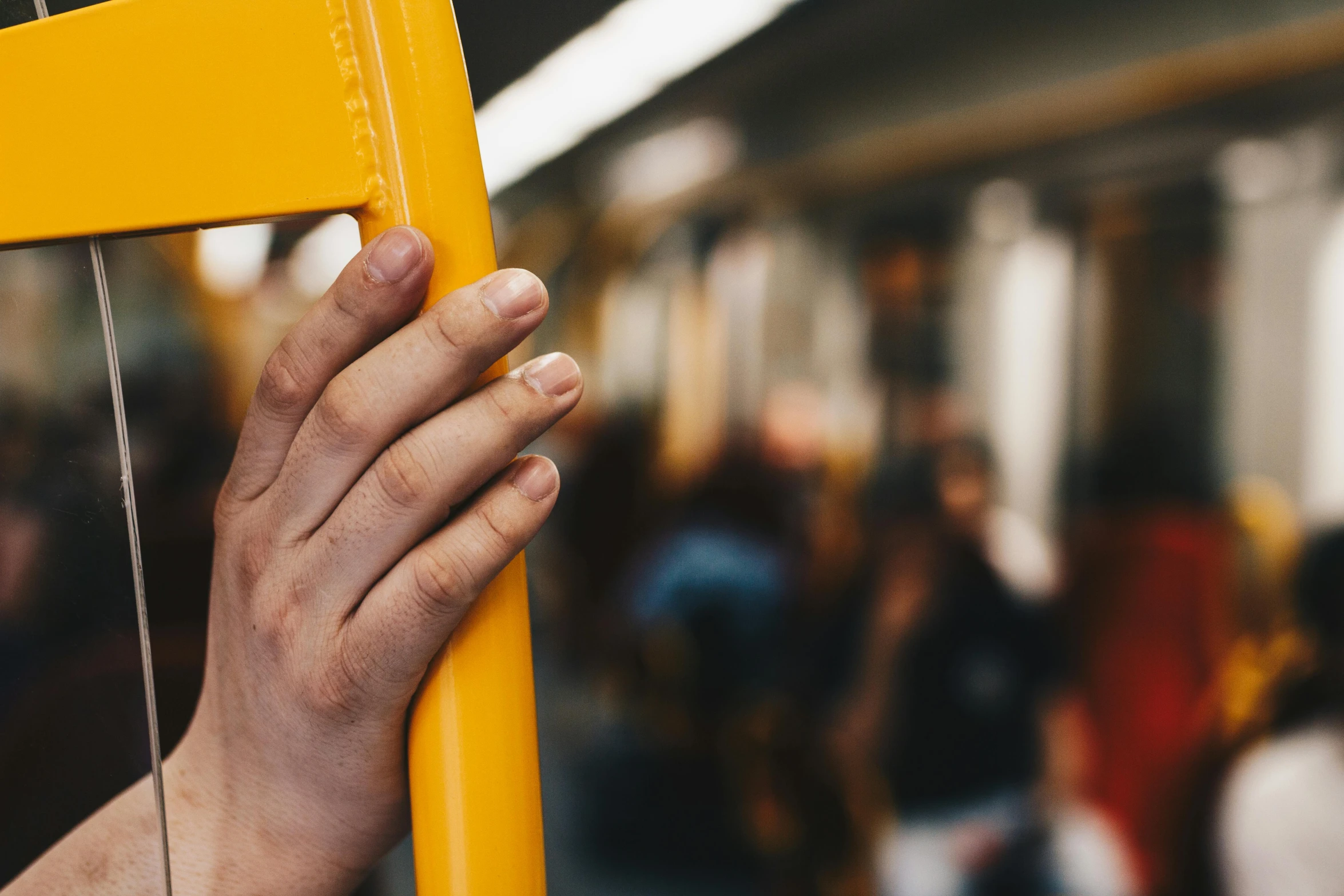 a close up of a person holding a yellow pole, happening, inside of a metro train, 🚿🗝📝, single pair of hands, thumbnail