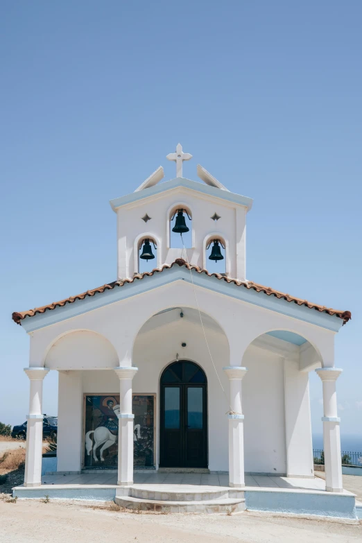 a small white church sitting on top of a hill, trending on unsplash, cyprus, frontal view, multiple stories, color image