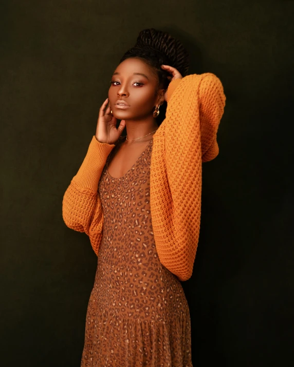 a woman in a brown dress posing for a picture, inspired by Chinwe Chukwuogo-Roy, trending on pexels, renaissance, cardigan, orange hue, willow smith young, high resolution product photo