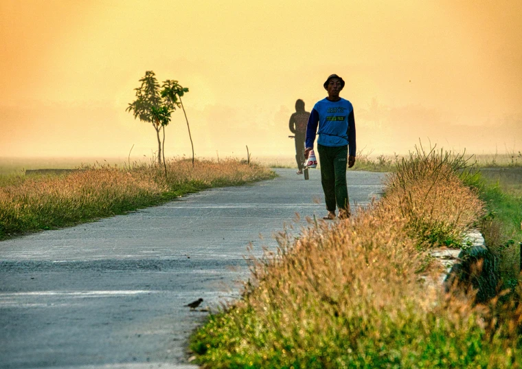 a couple of people that are walking down a road, by Eglon van der Neer, pexels contest winner, assam tea village background, fading off to the horizon, beautiful morning, foot path