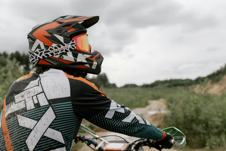 a man riding a dirt bike down a dirt road, a picture, pexels contest winner, figuration libre, white and orange breastplate, profile picture, a green, gray