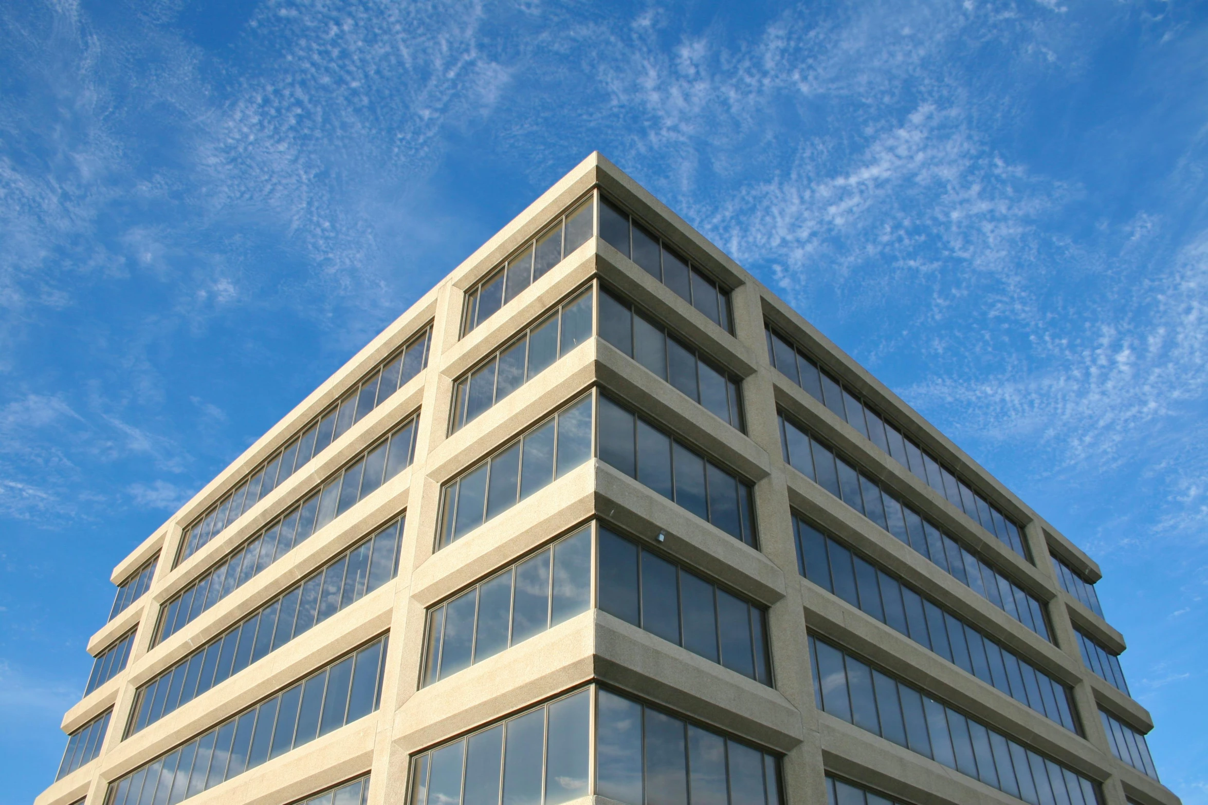 a very tall building with lots of windows, a photo, by Washington Allston, corner office background, sky made of ceiling panels, thumbnail, eyelevel perspective image