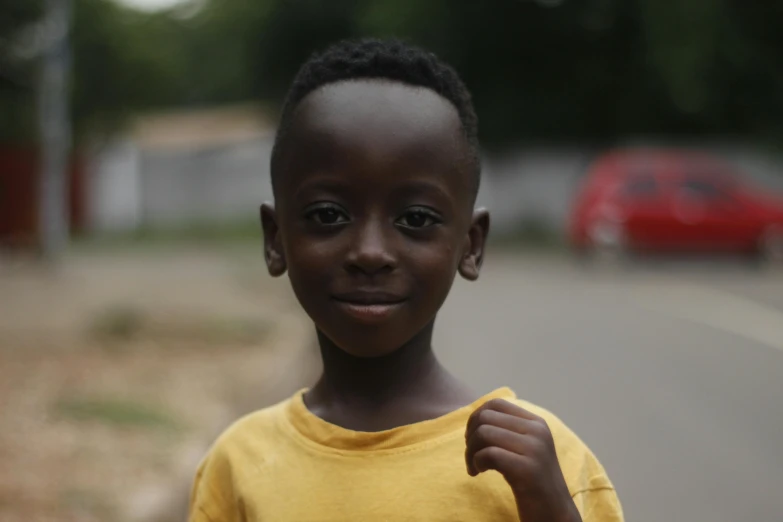 a young boy standing on the side of a road, pexels contest winner, happening, african facial features, avatar image, fair skinned, ( brown skin )