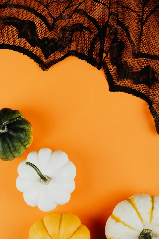 a group of pumpkins sitting on top of a table, laced lingerie, background image, vibrant aesthetic, candy treatments