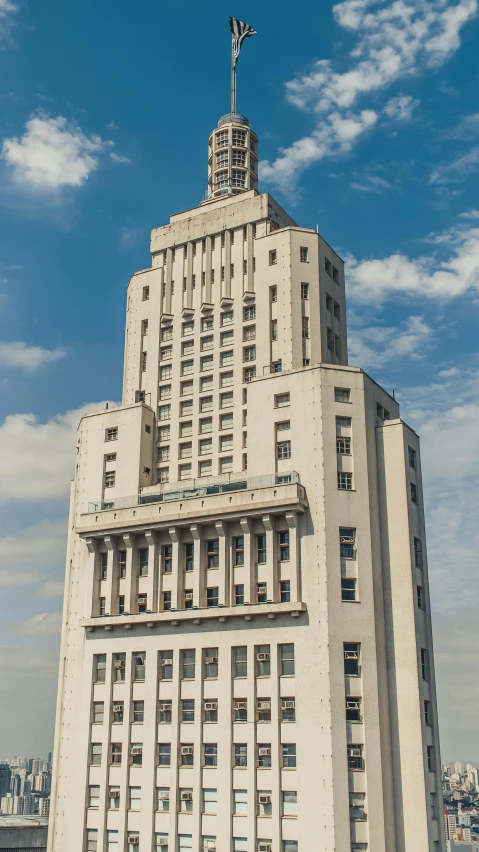 a tall building with a clock on top of it, an art deco sculpture, inspired by Józef Pankiewicz, brutalism, towering high up over your view, large hall, neoclassical style, surrounding the city