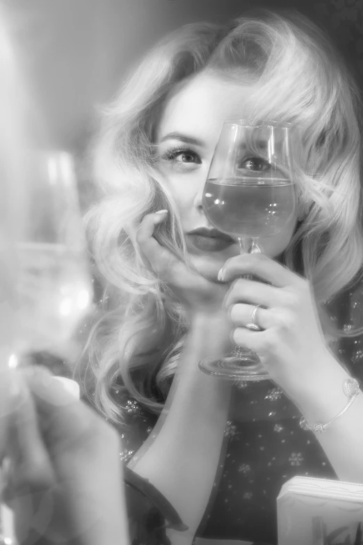 a woman sitting at a table with a glass of wine, a black and white photo, inspired by George Hurrell, featured on cgsociety, photorealism, curly blond, double exposure of love, chloe moretz, detail