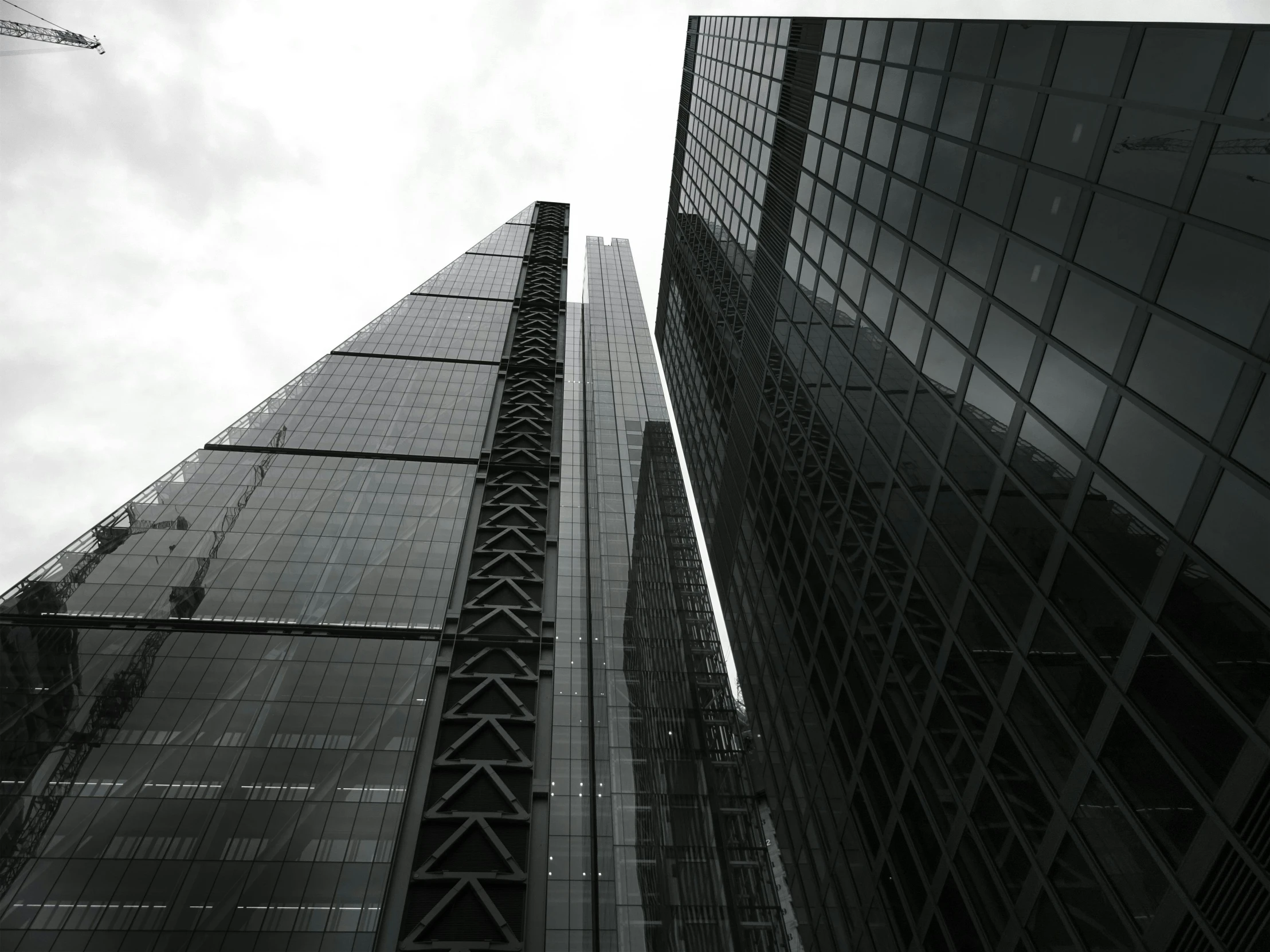 a black and white photo of a tall building, inspired by Thomas Struth, unsplash, mirror's edge in russia, three towers, sleek glass buildings, square lines