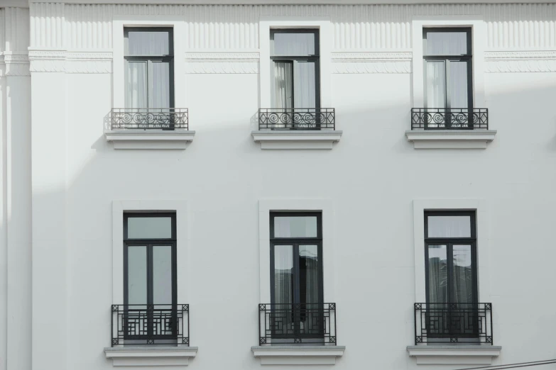 a white building with lots of windows and balconies, pexels contest winner, neoclassicism, black windows, vray smooth, minimalist photorealist, exterior view