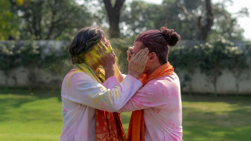 a couple of women standing next to each other, pexels contest winner, color field, celebrating an illegal marriage, hindu, two men hugging, splash of color