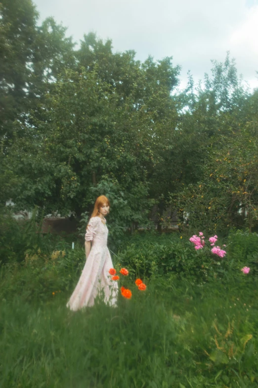 a woman in a white dress standing in a field of flowers, an album cover, inspired by Oleg Oprisco, unsplash, romanticism, in shades of peach, in a garden of a house, anna nikonova aka newmilky, low quality footage