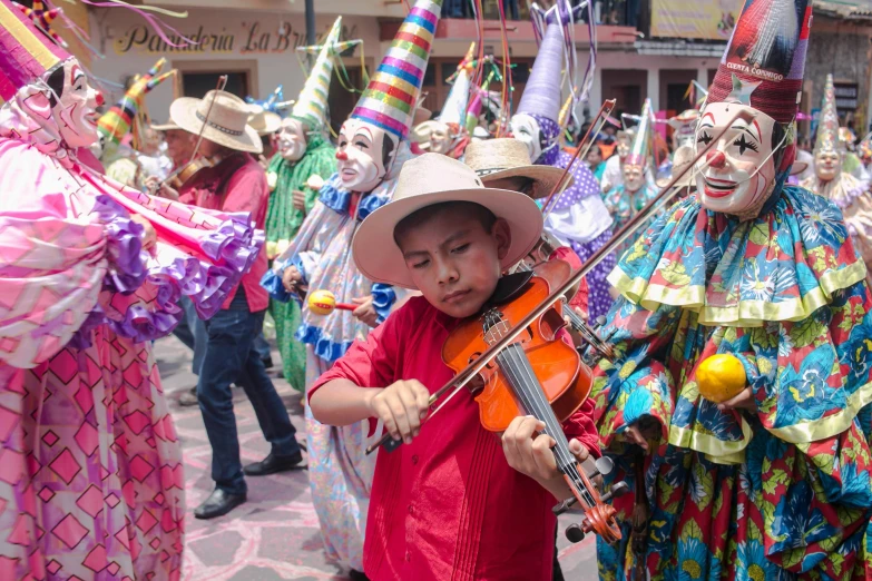 a young boy playing a violin in a parade, an album cover, pexels, quito school, masked female violinists, sombrero, avatar image