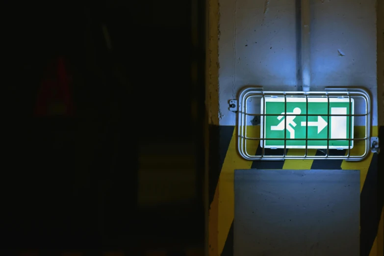 a sign that is on the side of a building, inspired by Elsa Bleda, unsplash, exit light, worksafe. instagram photo, pictogram, rescue from the underworld